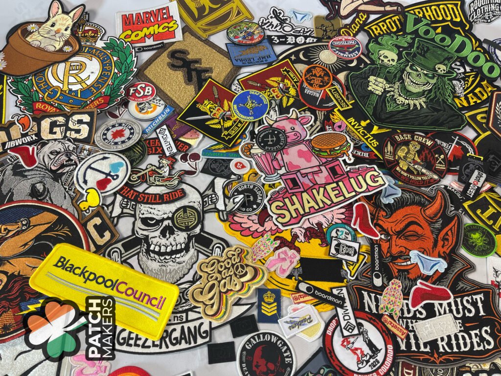 Collection of custom embroidered patches including biker patches, logo patches, military patches, morale patches, and promotional embroidered badges made in Ireland.
