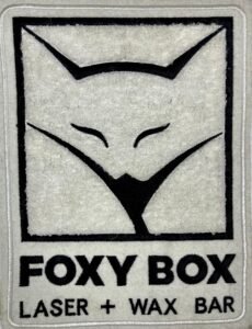 Custom white chenille patch with FOXY BOX logo and laser wax bar branding